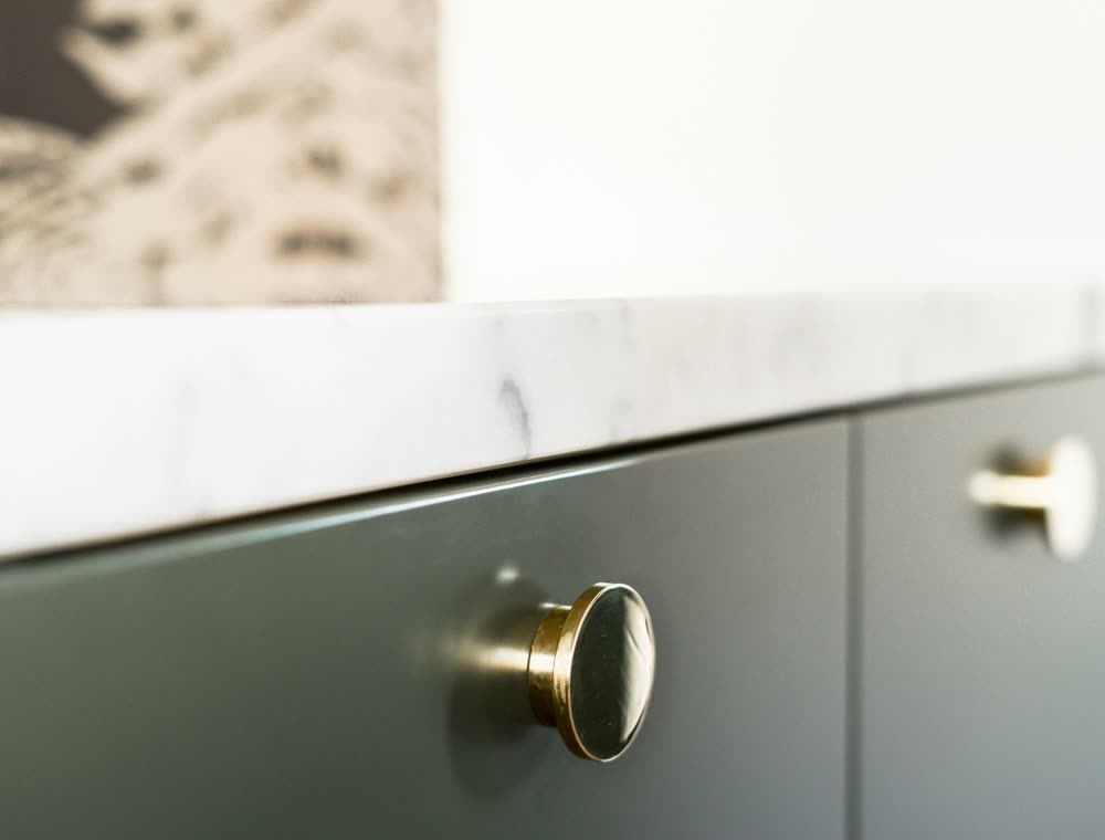 Brass knob on a painted cabinet front
