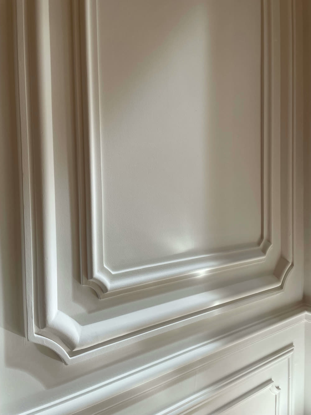 Close view of a painted molded panel corner
